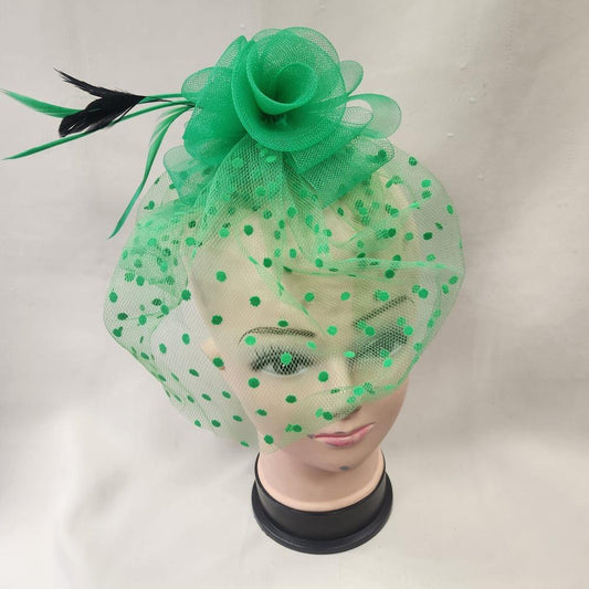 Green fascinator with mesh and feather detail