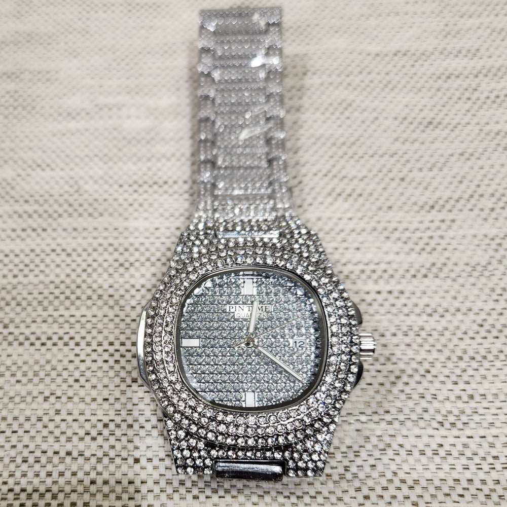 Detailed view of wrist watch in silver with stone embellished strap and dial