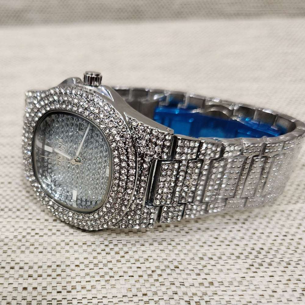 Side view of wrist watch in silver with stone embellished strap and dial