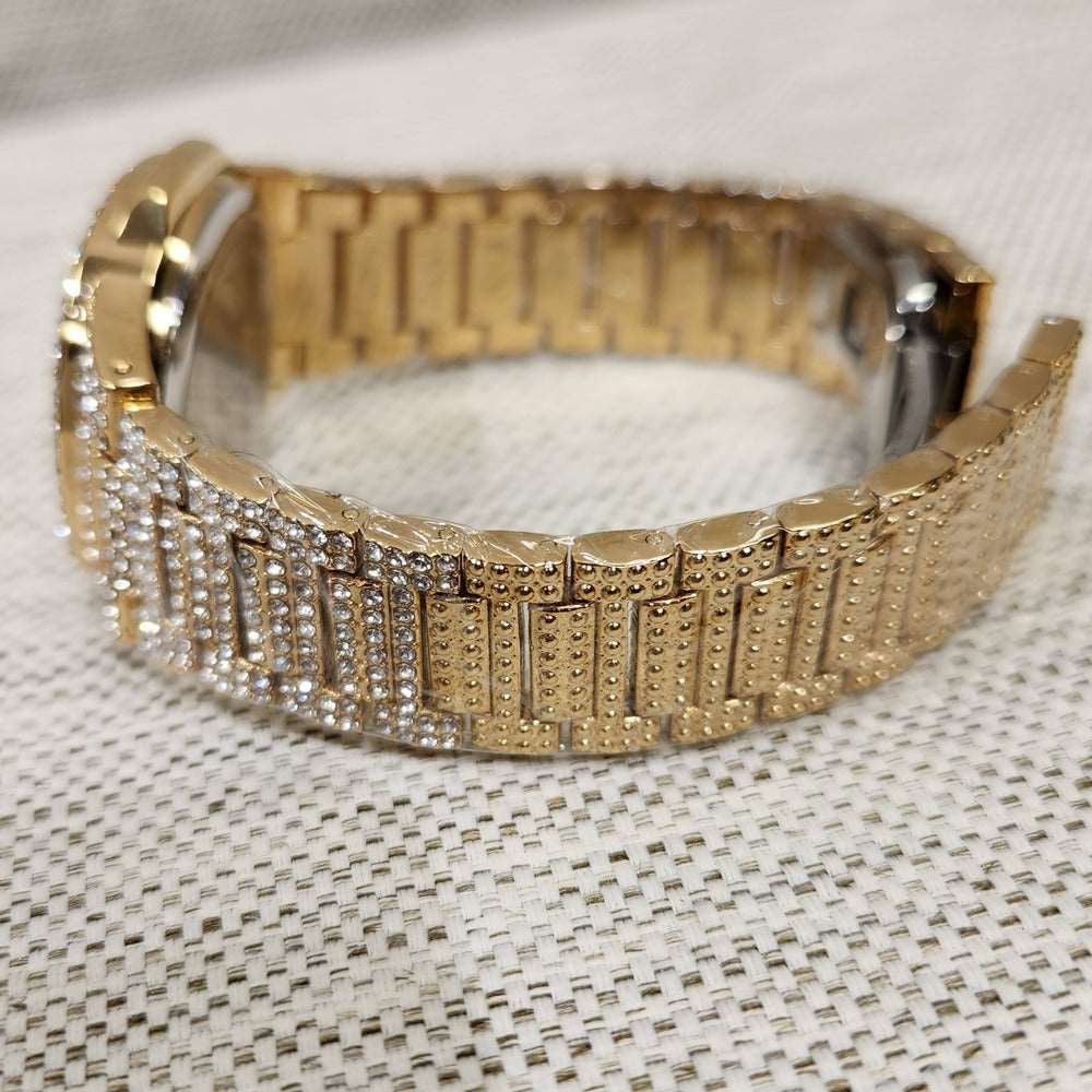 Detailed view of strap of gold square face wrist watch