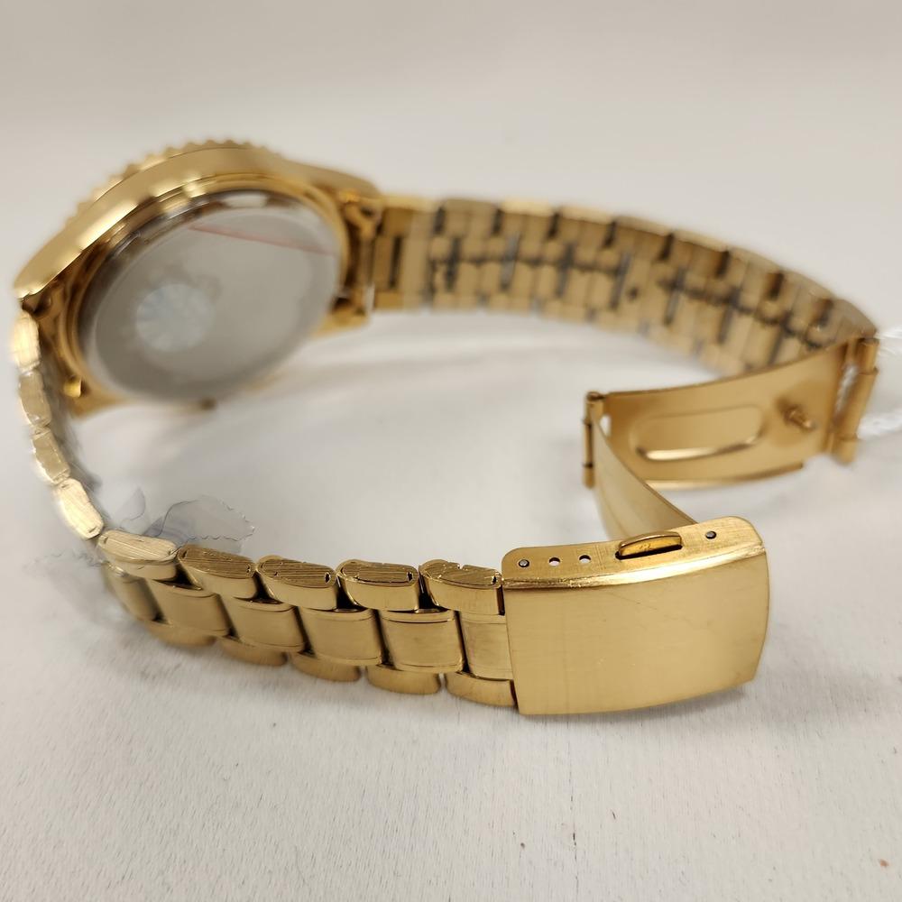 View of folding clasp and gold chain of wristwatch