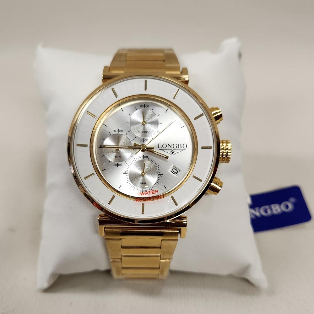Detailed view of wrist watch in gold with white round face 