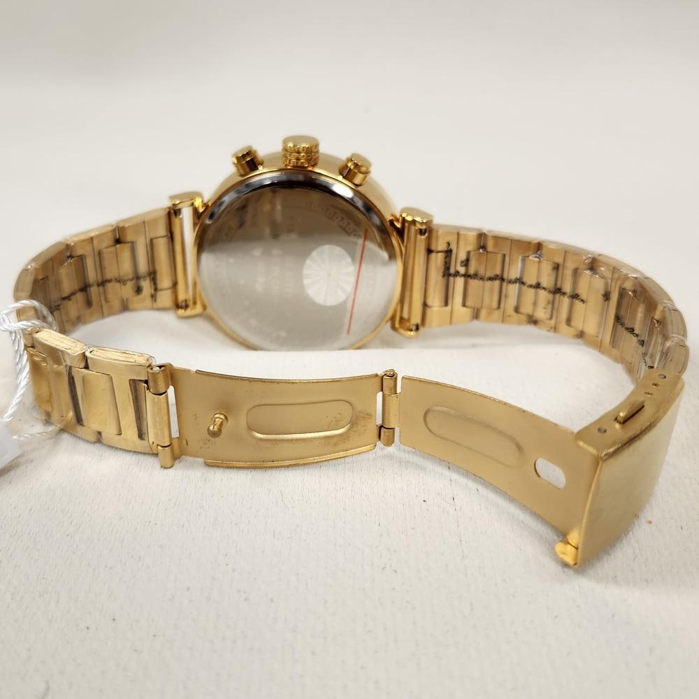 Folding clasp of wrist watch in gold with white round face 