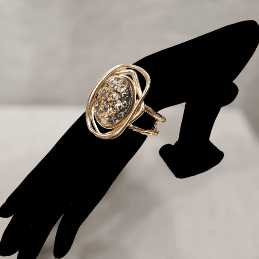 Hinged bracelet with resin filled center stone on a mannequin stand