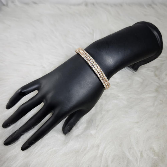 Classy gold bracelet with multiple rows of clear stones