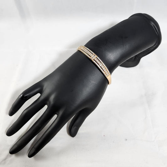 Elegant gold bracelet with baguette shaped center stone