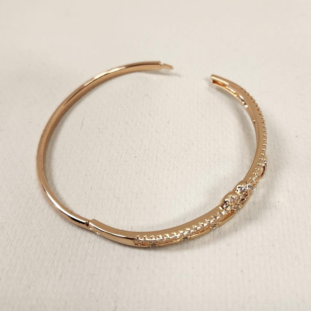 Dainty heart & bow stone embellished gold bracelet when opened