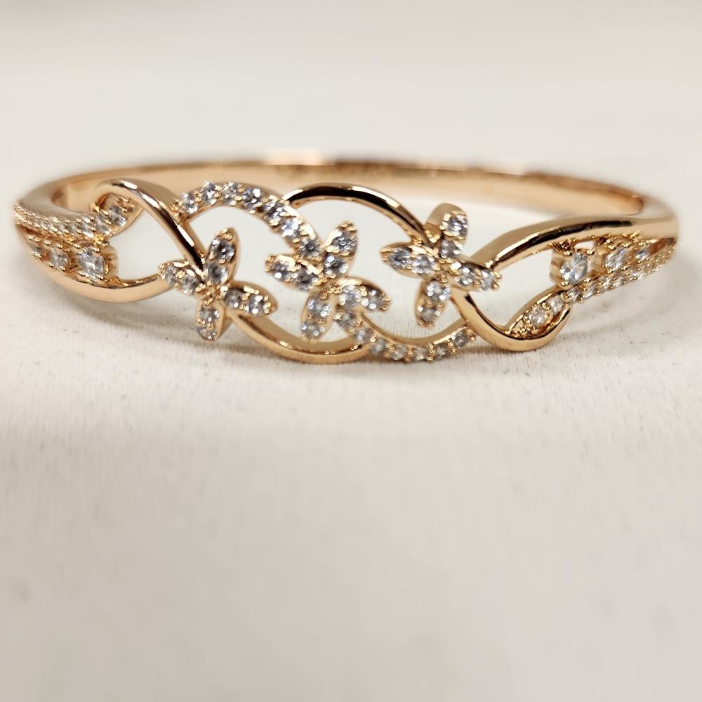 Front view of Dainty gold bracelet with floral design feature