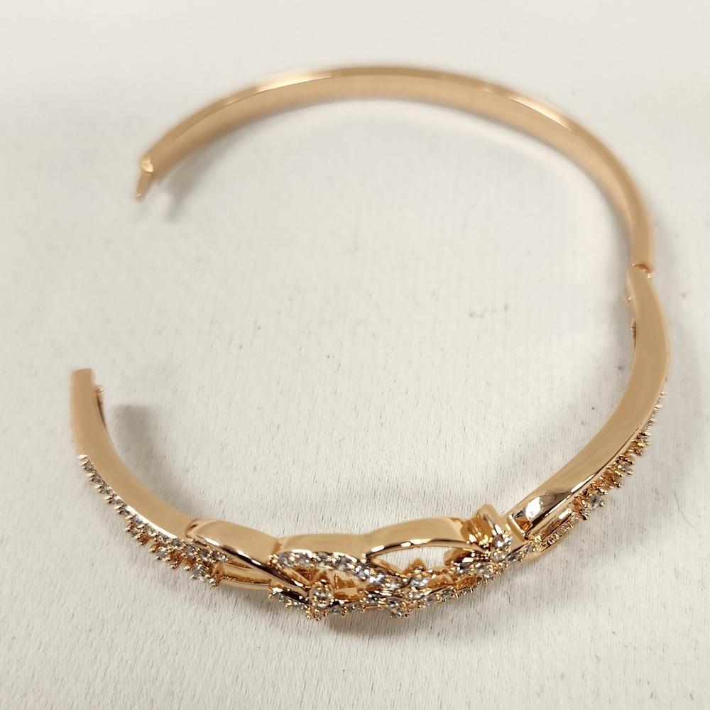 Dainty gold bracelet with floral design feature when opened