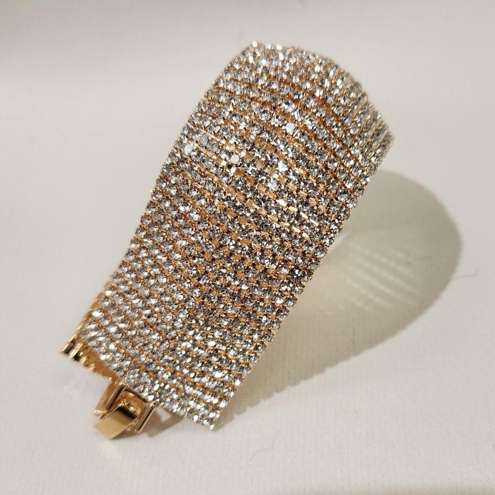 Another view of Stone studded gold bracelet with fold over clasp