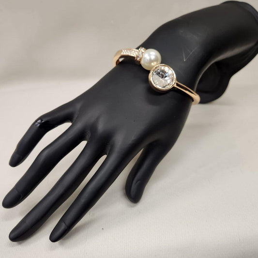 Gold bracelet with clear stones and pearl