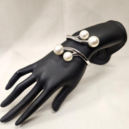 Silver hued hinged bracelet with pearl embellishment