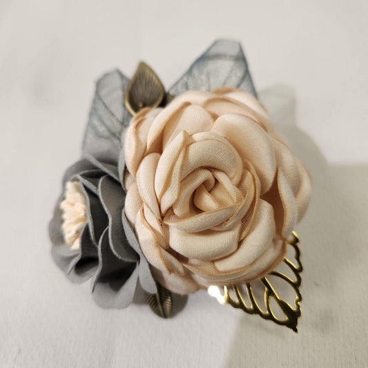 Another view of brooch and hair clip in shades of cream and grey