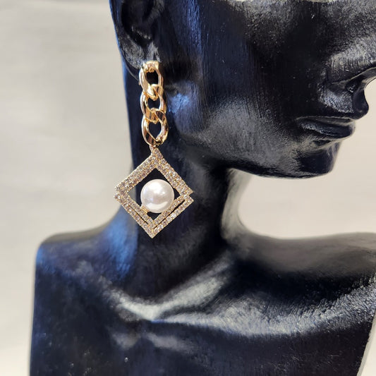 Gold frame dangle earrings with pearl and stone setting