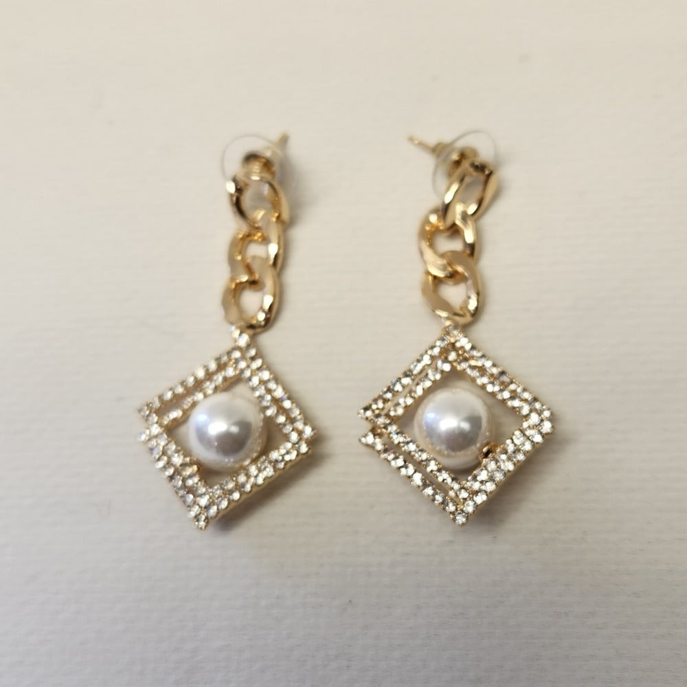 Another view of Gold frame dangle earrings with pearl and stone setting 