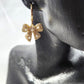 Detailed view of dangling bow earrings
