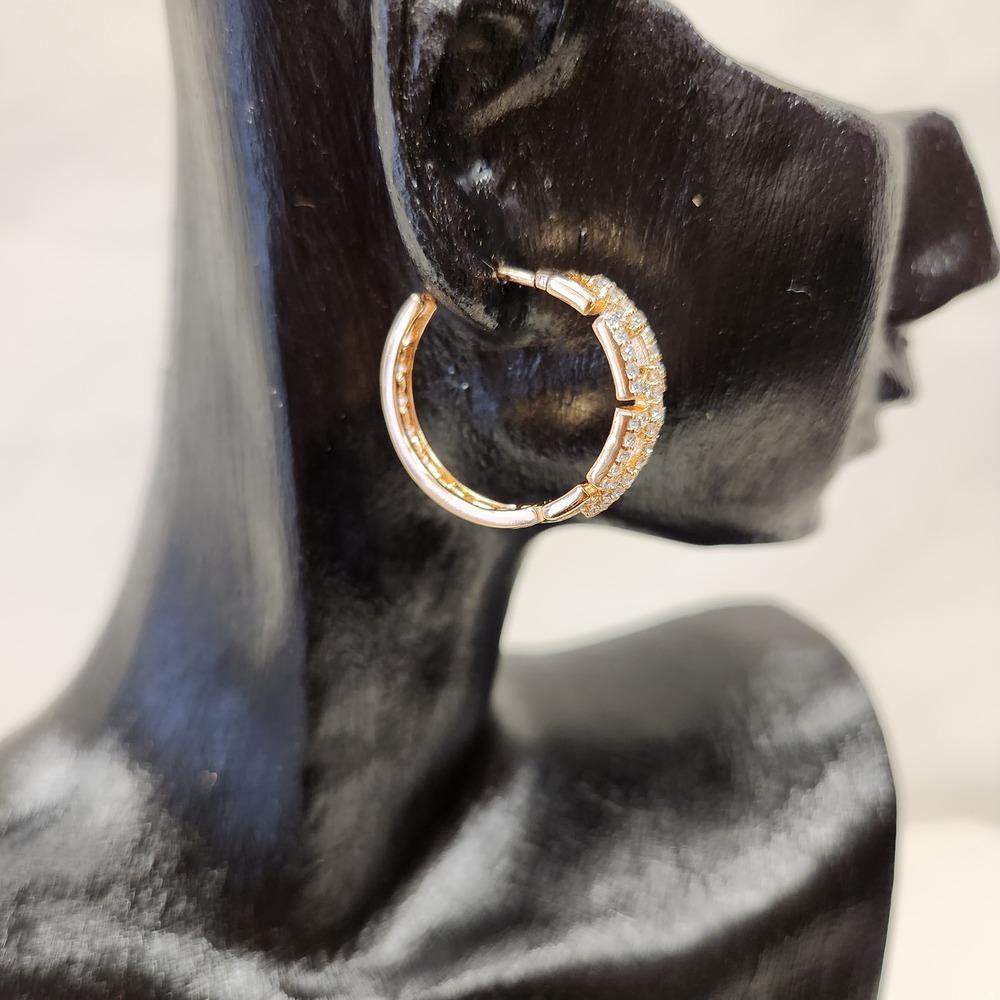 Side view of mid size hoop earrings with loop chain design detail