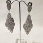 Long silver color stone studded dangle earrings