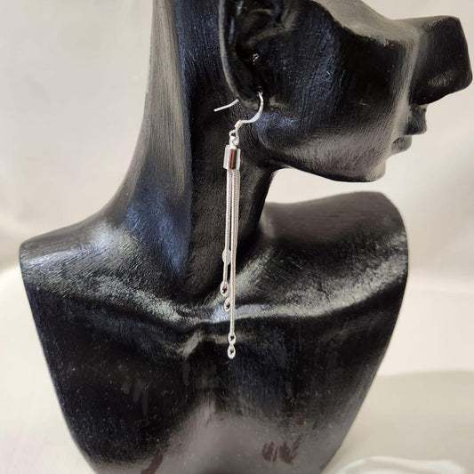 Long silver color dangle earrings with oval beads