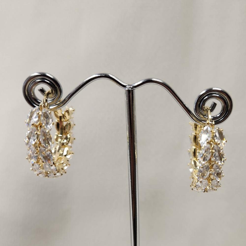 Detailed view of Gold hoop earrings with marquise cut stones