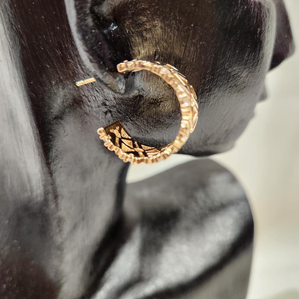 Detailed side view of Gold open hoop earrings with stones