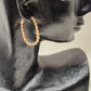 Side view of Delicate gold hoops with bezel fit clear stone