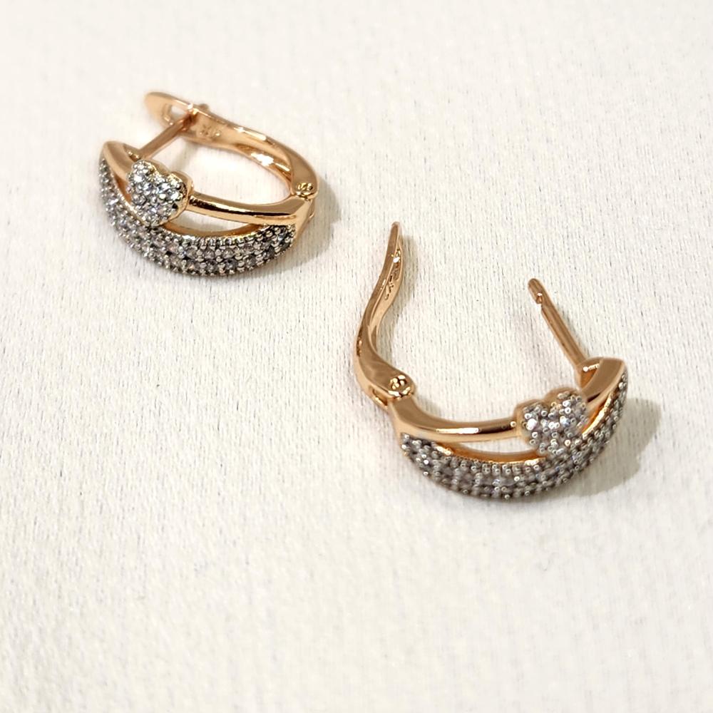 Latch back post of small gold hoop earrings with stones