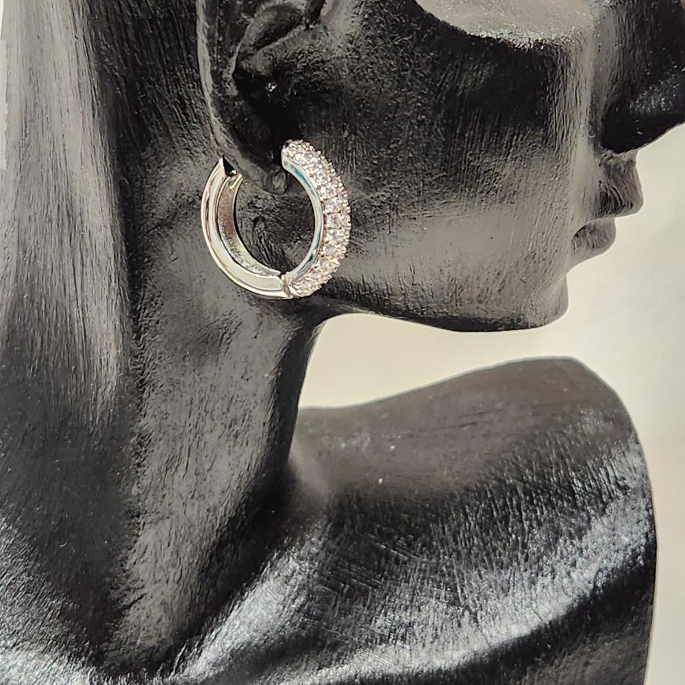 Side view of Silver frame hoop earrings with rows of stones