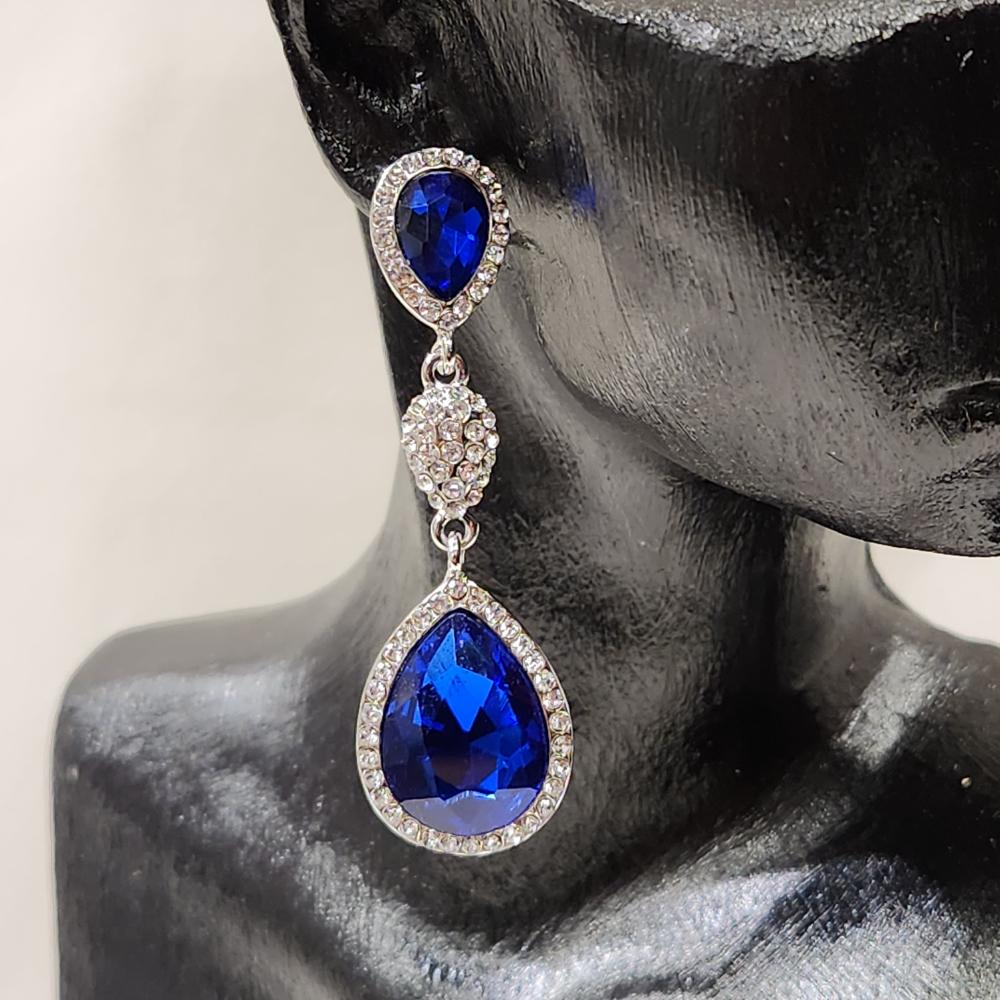 Detailed view of Silver frame dangle earrings with clear and blue stones