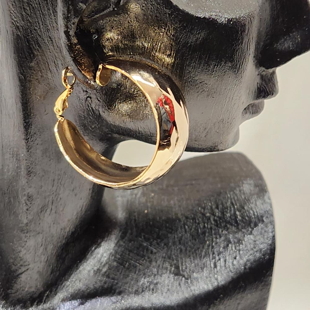Side view of Wide textured open hoop earrings