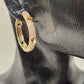 Detailed view of Gold hoop earrings with embossed hearts