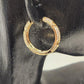 Side view of Gold hoop earrings with embossed hearts