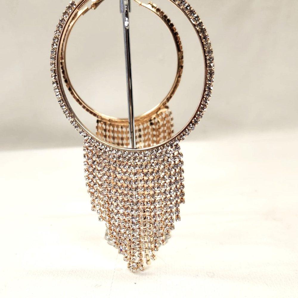 Detailed view of Gold frame stone studded large hoops
