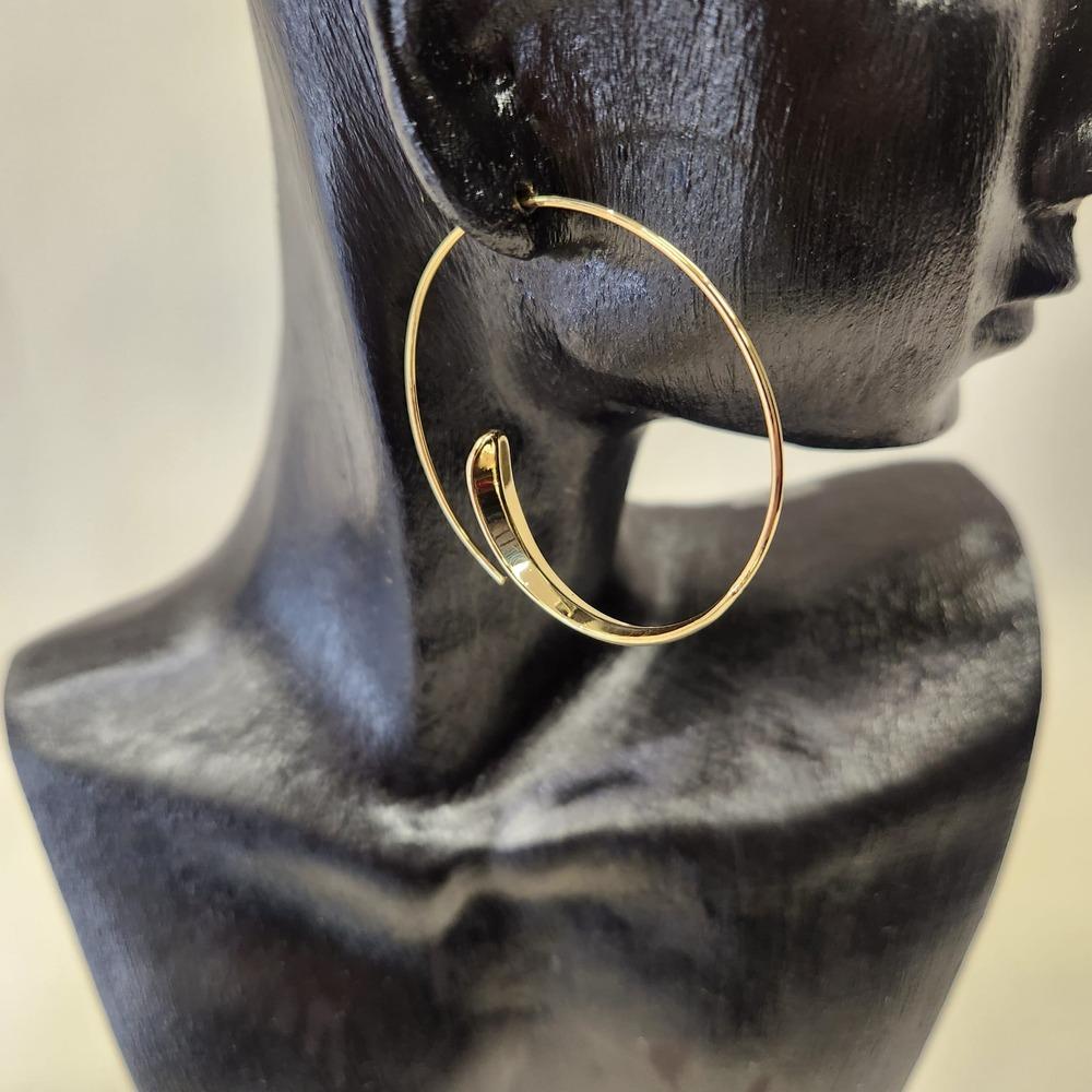 Detailed view of Modish large gold hoop earrings