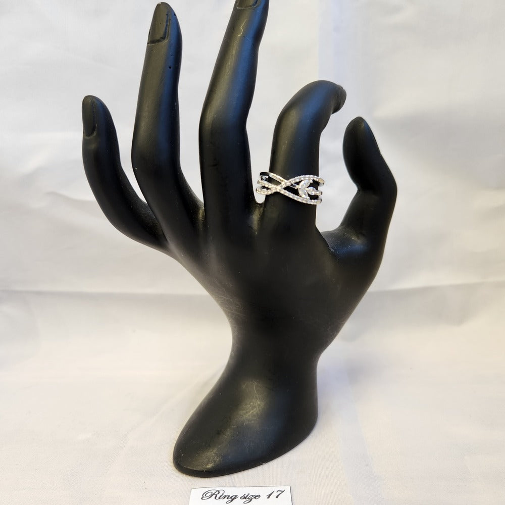 Delicate silver color ring displayed on mannequin stand