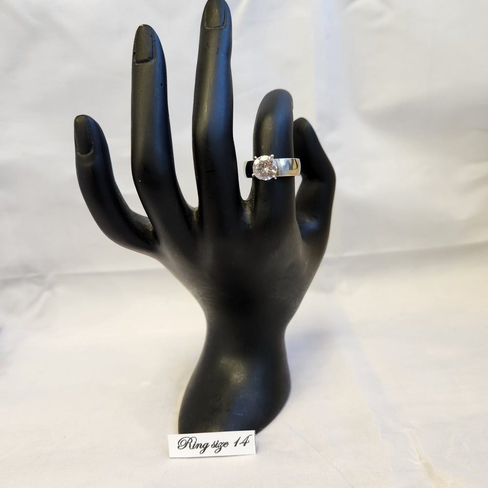 Silver colored ring displayed on a mannequin stand