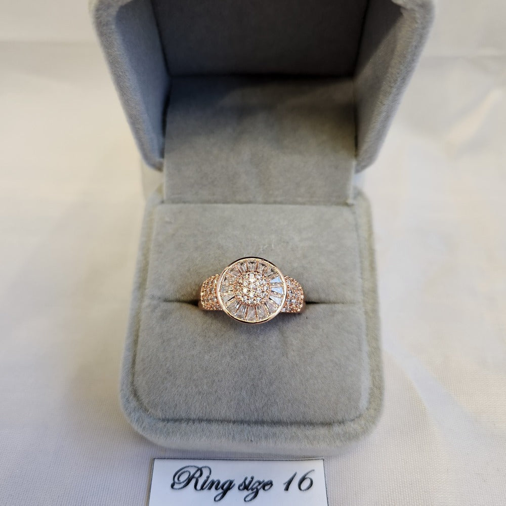Rose gold halo style ring with round and baguette stones