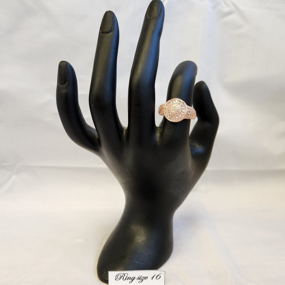 Rose gold halo style ring displayed on mannequin stand
