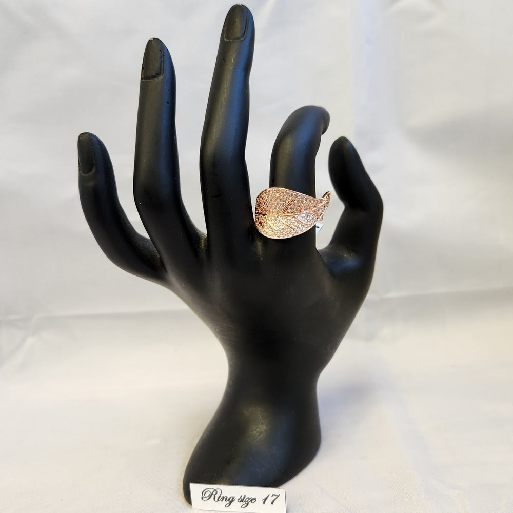 Rose gold leaf shaped stone studded ring displayed on a mannequin stand