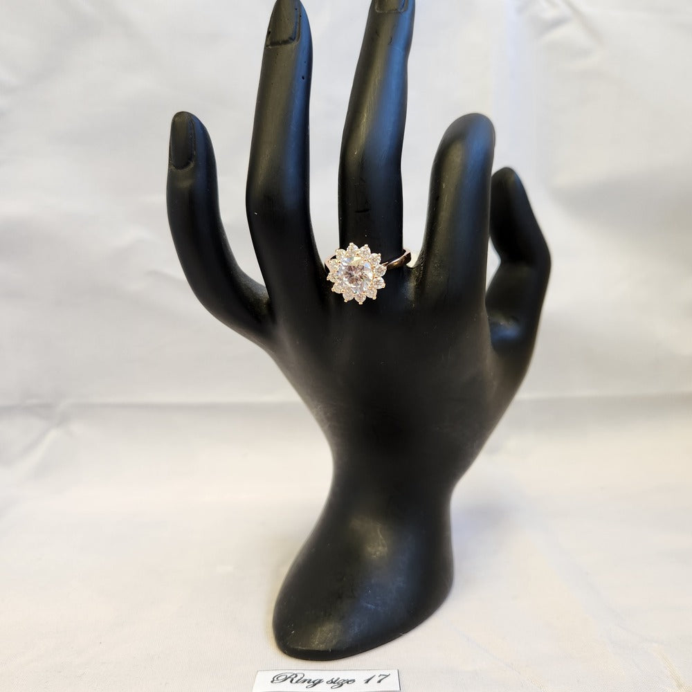 Classic halo shaped ring in gold color frame displayed on mannequin stand
