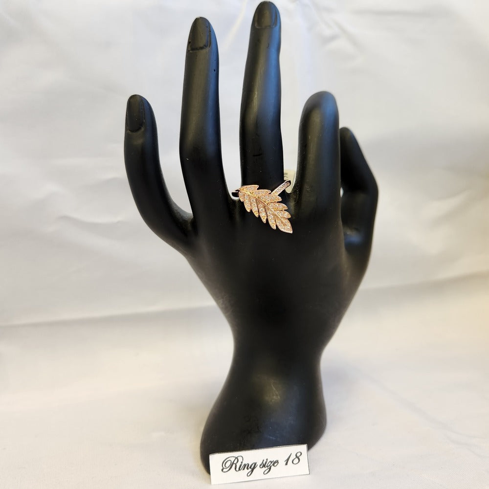 Leaf shaped rose gold ring in size 18 displayed on a mannequin stand