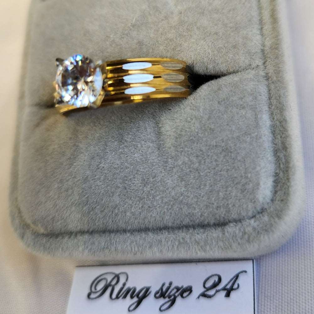 Detailed view of dual tone ring with dazzling prong set stone