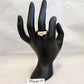 Dual tone ring with dazzling prong set stone on mannequin stand