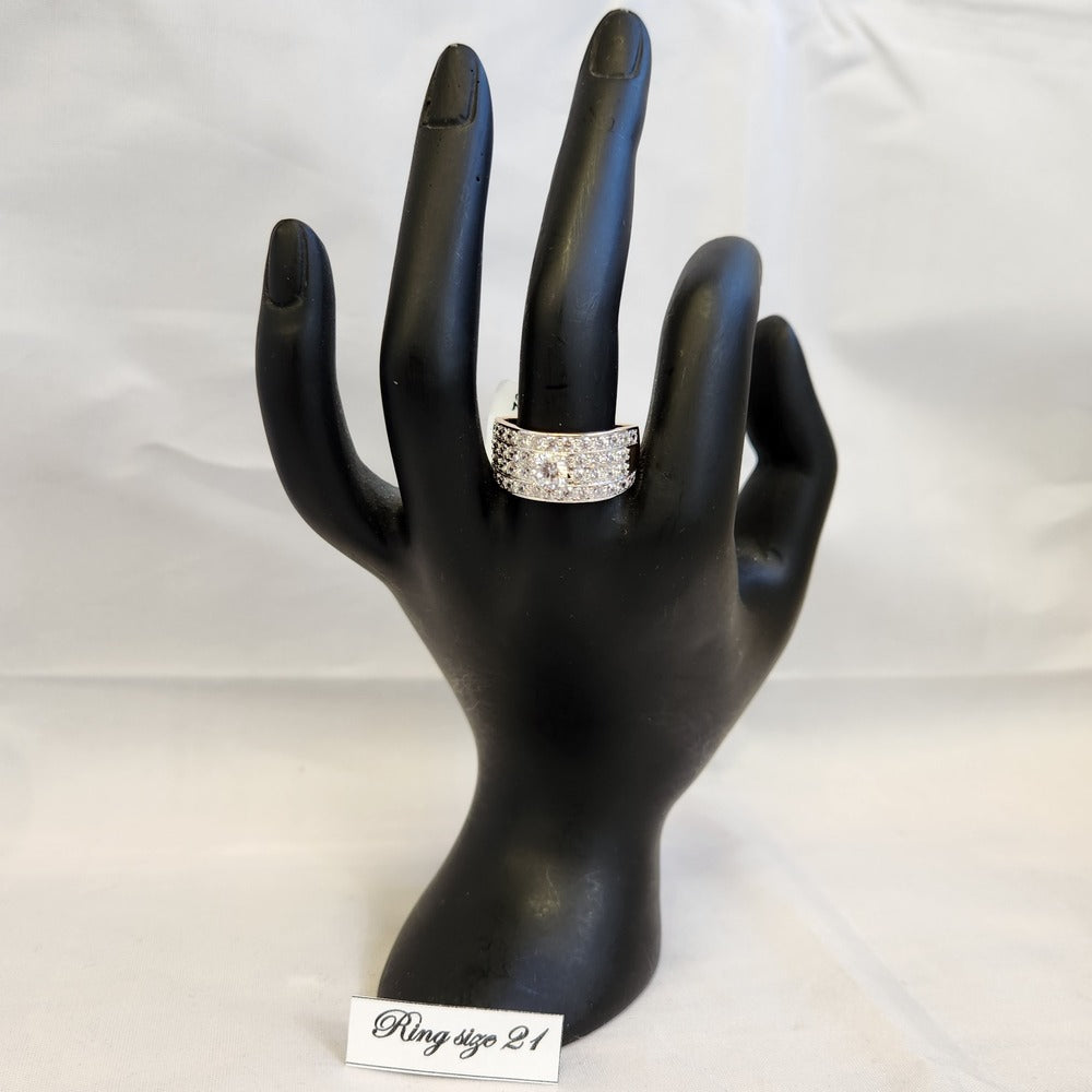 Another view of wide gold band ring on a mannequin stand