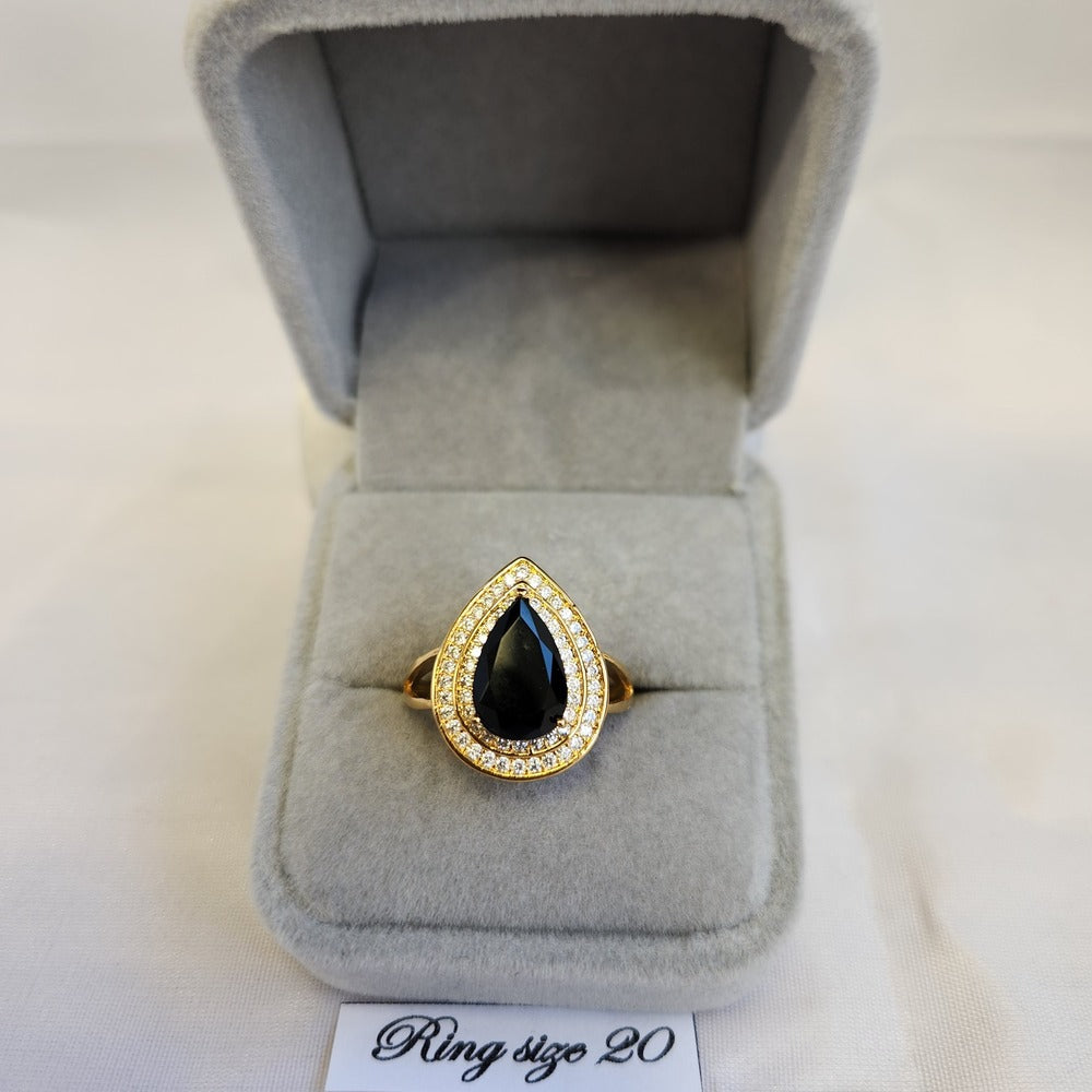 Gold color ring with black pear shaped center stone