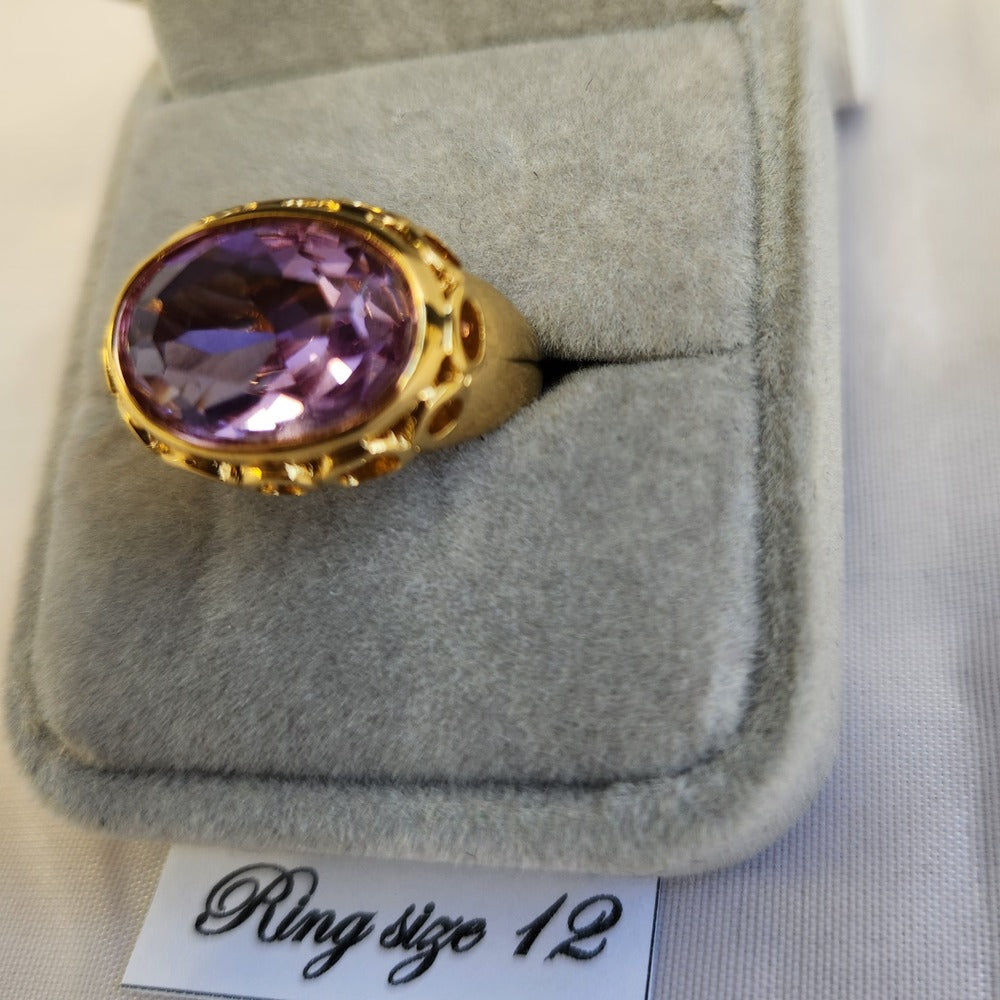Detailed view gypsy style gold color ring with lavender center stone
