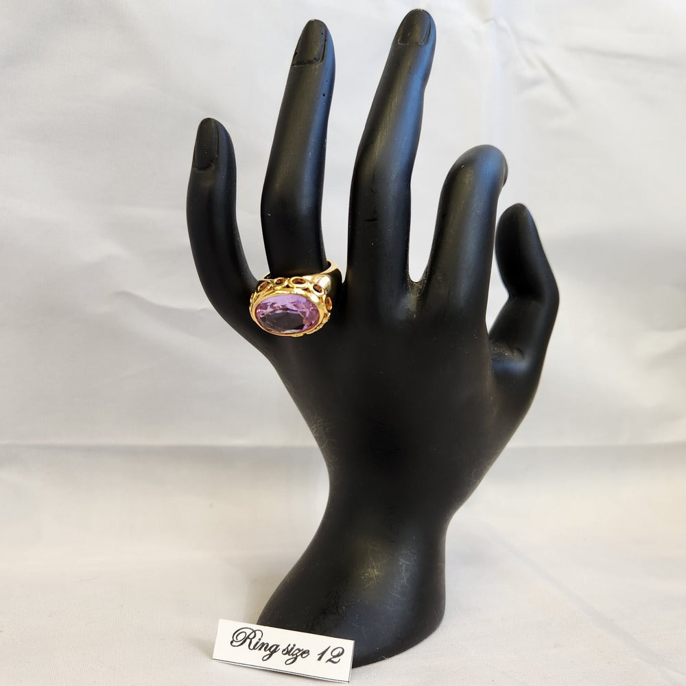Gypsy style gold color ring displayed on a mannequin stand