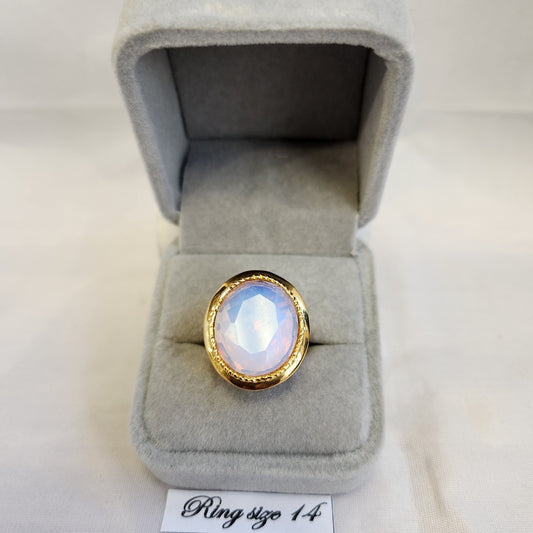 Bold gold frame ring with AB color center stone