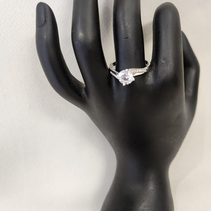 Solitaire style ring with stone studded shoulder