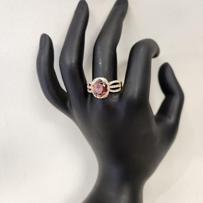 Beautiful gold frame ring with oval red center stone